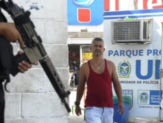 Armed police officer and resident of Parque Proletário, in the Complexo da Penha (Tânia Rêgo/Agência Brasil)
