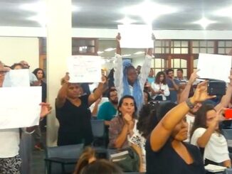 Residents hold banners calling for an end to violence.