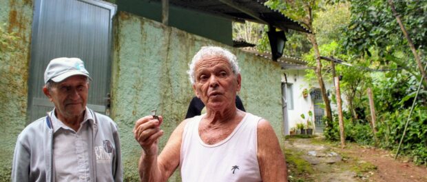 Seu Zeca holds his grandfather's whistle, who was one of the old guards of the Botanical Gardens.