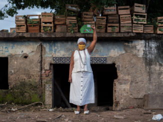 Mãe Ekedi Sílvia de Mendonça, a journalist and a Black Movement activist, in front of the old house of cult of João da Gomeia, one of the most famous candomblé priests of his time. Photo by Bárbara Dias