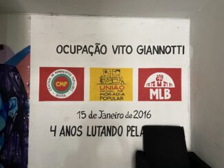 The entrance of the Vito Giannotti occupation with the symbols of the social movements fighting for housing and responsible for its organization