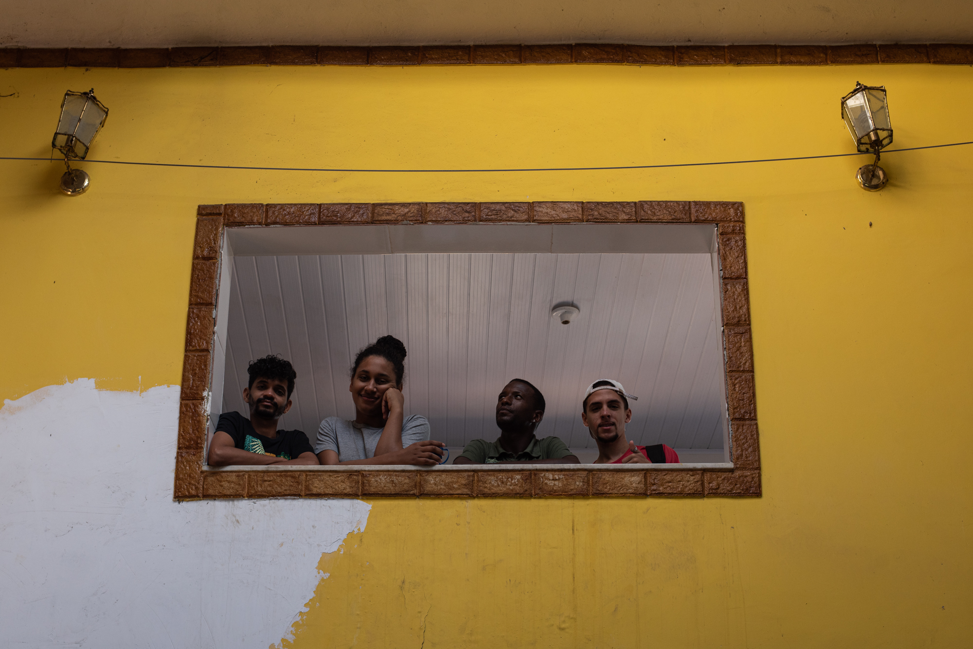 Casa Dulce Seixa residents pose for a photo at the window of their home. Photo: Bárbara Dias