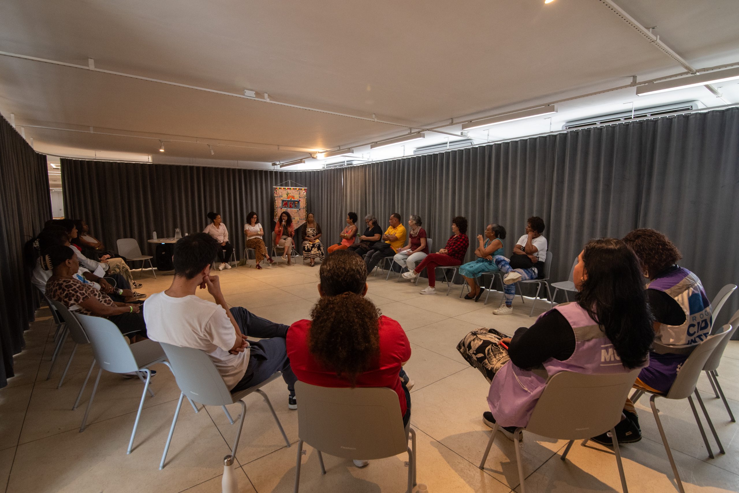 During the opening of the exhibition at MUF, a group of women gathered for the discussion circle ‘Dialogues on the Network for the Protection of Women, Support Pathways and Protective Leadership,’ facilitated by CAOVIDMPRJ. Photo: Bárbara Dias During the opening of the exhibition at MUF, a group of women gathered for the discussion circle ‘Dialogues on the Network for the Protection of Women, Support Pathways and Protective Leadership,’ facilitated by CAOVIDMPRJ. Photo: Bárbara Dias